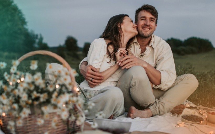 Eating dinner together at a local park for a second date